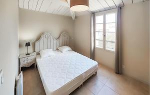 a bedroom with a large white bed and a window at Amazing Home In Saint-Laurent-De-La-Cabrerisse in Saint-Laurent-de-la-Cabrerisse