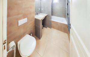 a bathroom with a toilet and a sink and a tub at Amazing Home In Saint-Laurent-De-La-Cabrerisse in Saint-Laurent-de-la-Cabrerisse +20 photos