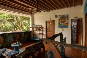 a living room with a wooden floor and a window at Casa Surf Mar Azul in Palomino +32 photos