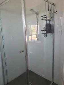 a shower with a glass door in a bathroom at Tranquil Studio Apartment Just 3km from Port Pirie in Port Pirie