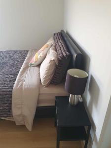 a bed with pillows and a lamp on a table at Tranquil Studio Apartment Just 3km from Port Pirie in Port Pirie