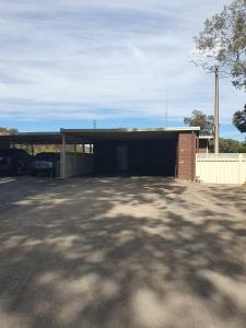 a garage with a building with a car parked in it at Tranquil Studio Apartment Just 3km from Port Pirie in Port Pirie