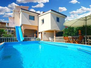 a swimming pool with a slide in front of a house at Ferienwohnung für 4 Personen ca 55 qm in Ližnjan, Istrien Südküste von Istrien in Ližnjan