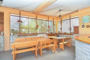 a dining room with wooden tables and windows at Ferienwohnung für 4 Personen ca 55 qm in Ližnjan, Istrien Südküste von Istrien in Ližnjan +14 photos