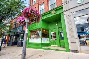 a green store front with flowers on a street at The Avonlea Inn in Stratford