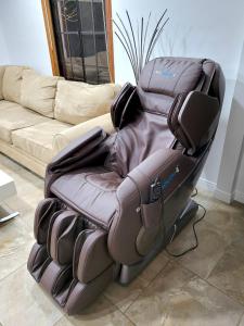 a massage chair sitting in front of a couch at House In Lake Balboa/Los Angeles in Los Angeles