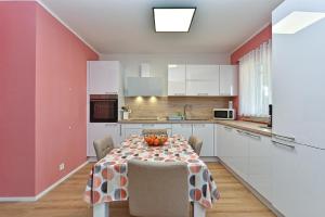 cocina con mesa y sillas en una habitación en Ferienwohnung für 4 Personen ca 72 qm in Medulin, Istrien Südküste von Istrien, en Medulin