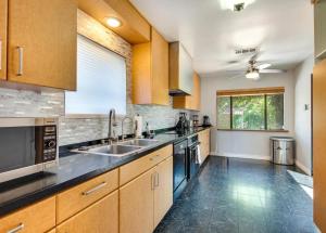 a large kitchen with wooden cabinets and a sink at House In Lake Balboa/Los Angeles in Los Angeles