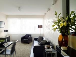a living room with a couch and a table at VISIONAPARTMENTS Rue Caroline - self check-in in Lausanne