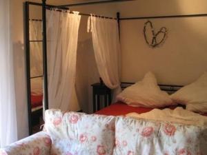 a bedroom with a canopy bed with a mirror at Ferienwohnung in Horben mit Großem Garten in Horben