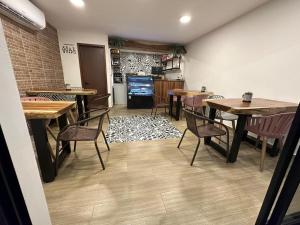 a dining room with tables and chairs and a tv at HOTEL PALENQUE PREMIER in Palenque