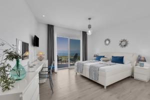 - une chambre blanche avec un lit et une vue sur l'océan dans l'établissement Ferienhaus mit Privatpool für 8 Personen ca 340 qm in Makarska, Dalmatien Mitteldalmatien, à Makarska