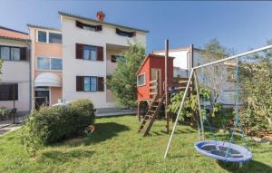 een tuin met een schommel en een huis bij Ferienwohnung für 3 Personen ca 34 qm in Valbandon, Istrien Istrische Riviera in Valbandon