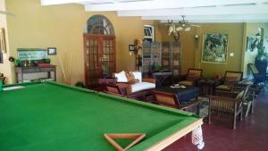 a living room with a pool table and furniture at Old Mine Guesthouse in Musina