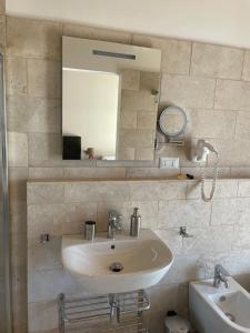 a bathroom with a sink and a mirror at Casa Natura 40 in Parghelia +81 photos