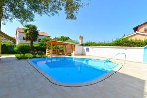 una piscina en el patio trasero de una casa en Ferienwohnung für 8 Personen ca 120 qm in Stancija Vinjeri Novigrad, Istrien Istrische Riviera, en Karpinjan
