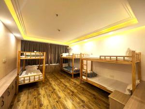 a room with three bunk beds in it at Fusion Hotel in Sihanoukville