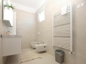 a white bathroom with a toilet and a window at Ferienwohnung für 4 Personen ca 50 qm in Banjole, Istrien Istrische Riviera - b55089 in Banjole