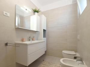 a bathroom with a sink and a toilet and a mirror at Ferienwohnung für 4 Personen ca 50 qm in Banjole, Istrien Istrische Riviera - b55089 in Banjole