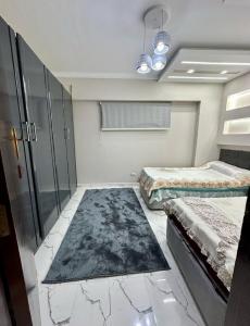 a room with two beds and a glass wall at Porto elsokhna pyramids VIP in ‘Atāqah