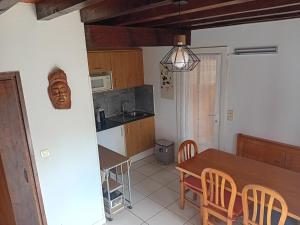 a kitchen and dining room with a table and chairs at Maison Hendaye, 3 pièces, 4 personnes - FR-1-239-1034 in Hendaye
