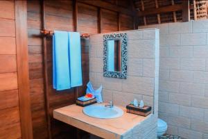 a bathroom with a sink and a mirror at Harta Lembongan Villas in Nusa Lembongan