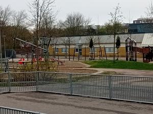 an empty park with a playground with a slide at Naza cool villa! in Malmö