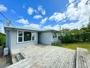 a house with a wooden deck in front of it at Serene Home in Whangarei in Whangarei