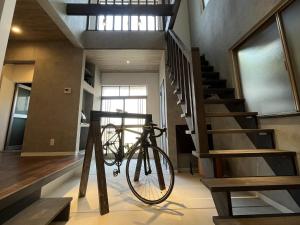 a bike on a stand in a room with stairs at KiCHi - Vacation STAY 15503 in Awaji