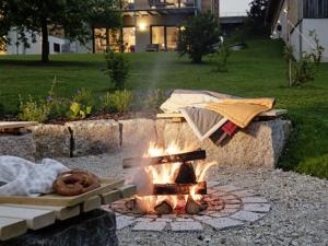 a fire pit in a yard with a blanket over it at STAY4 3 Modern retreat in Wunsiedel