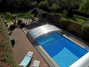 a large swimming pool with a domed roof at on the Werraufer Modern retreat 