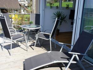 a group of chairs and a table on a porch at in the holiday home Sandra Comfortable holiday residence in Hörbranz