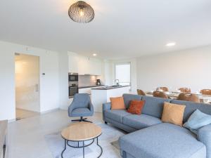 a living room with a couch and a table at Corner apartment in the center with 3 bedrooms in Middelkerke
