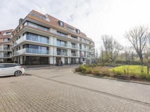 a white car parked in front of a building at Corner apartment in the center with 3 bedrooms in Middelkerke