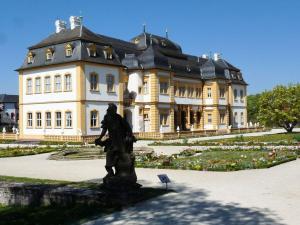 a statue in front of a large building at Black Modern Retreat 