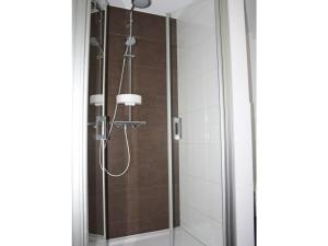 a shower in a bathroom with a glass door at im Penthouse am Wolfsberg in Lüdinghausen +28 photos
