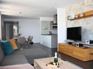a living room with a couch and a flat screen tv at im Penthouse am Wolfsberg in Lüdinghausen