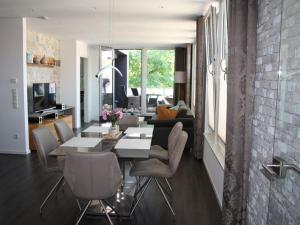 a living room with a table and chairs at im Penthouse am Wolfsberg in Lüdinghausen