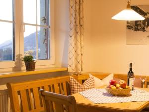 a dining room table with a bowl of fruit on it at 2 in Alpenrösle Modern retreat in Balderschwang