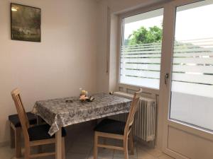 ein Esszimmer mit einem Tisch, Stühlen und einem Fenster in der Unterkunft Family Apartment Bavaria in Füssen