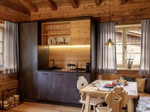 a kitchen with a table and a dining room at Alpglück Chalet Modern retreat in Oberstdorf