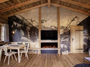 a dining room with a fireplace and a table at Alpglück Chalet Modern retreat in Oberstdorf