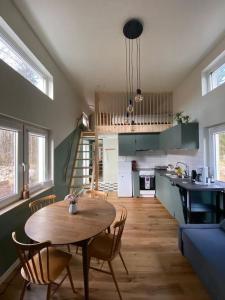 a kitchen and dining room with a table and chairs at Attefallshus. in Västervik