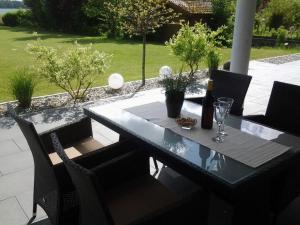 a black table and chairs on a patio at This year with lake view in Pönitz am See