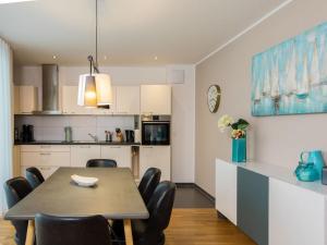 a kitchen and dining room with a table and chairs at Säntis Modern retreat in Friedrichshafen