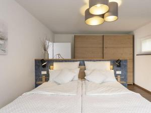 a bedroom with two beds and a chandelier at STAY4 2 Modern retreat in Wunsiedel