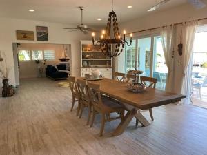 a dining room and living room with a table and chairs at Villa Bayside Beach in Fort Myers Beach