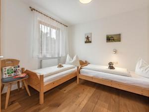 a bedroom with two beds and a window at Eisackblick Modern retreat in Brixen