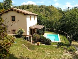 a house with a swimming pool in front of it at Ferienhaus mit Privatpool für 2 Personen 2 Kinder ca 70 qm in Uzzano, Toskana Provinz Pistoia in Uzzano