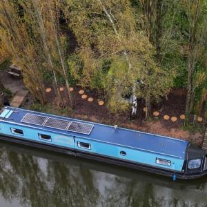 a boat with solar panels on the side of a river at Haw thorn Hideaway in Doncaster